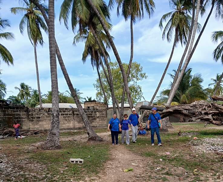 L'équipe de Médecins du Fleuve devant les palmiers